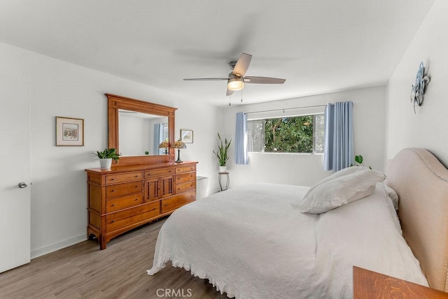 334 Gladys Ave Unit 103, Long Beach, CA 90814 - bedroom featuring a ceiling fan, wood finished floors, and baseboards
