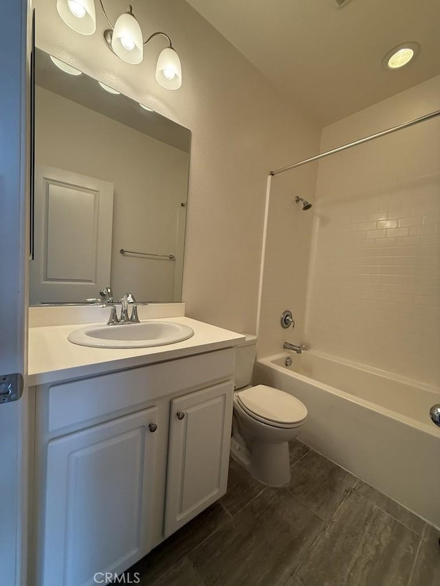 bathroom with vanity,  shower combination, and toilet