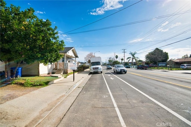 view of road with curbs, street lighting, and sidewalks