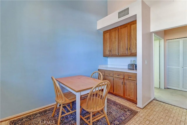 dining room featuring visible vents and baseboards