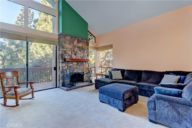 living area featuring high vaulted ceiling, carpet flooring, and a stone fireplace