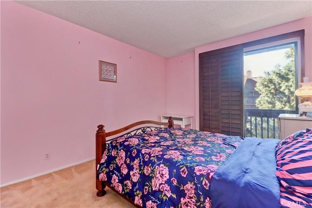 carpeted bedroom with a textured ceiling and baseboards