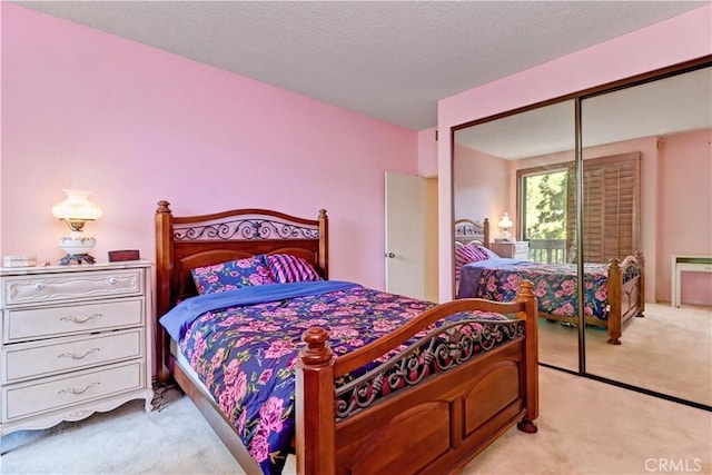 carpeted bedroom featuring a textured ceiling and a closet