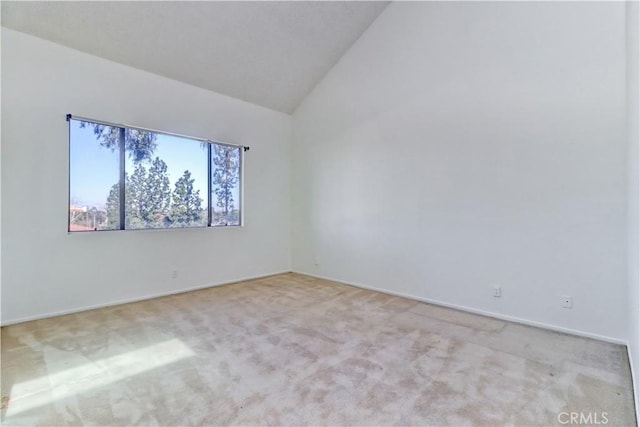 empty room with lofted ceiling and carpet flooring