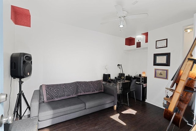 living area featuring stairs, wood finished floors, baseboards, and ceiling fan