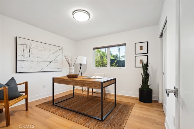 home office featuring light wood-style floors and baseboards