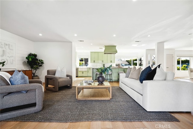 living area featuring wood finished floors and recessed lighting