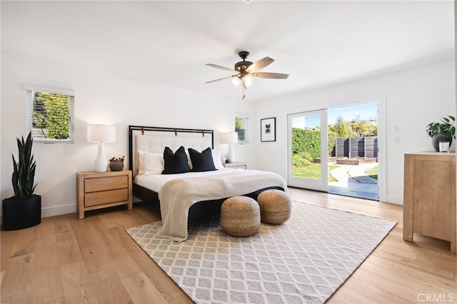 bedroom featuring access to exterior, light wood-style flooring, baseboards, and a ceiling fan