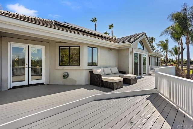 wooden deck featuring an outdoor living space and french doors