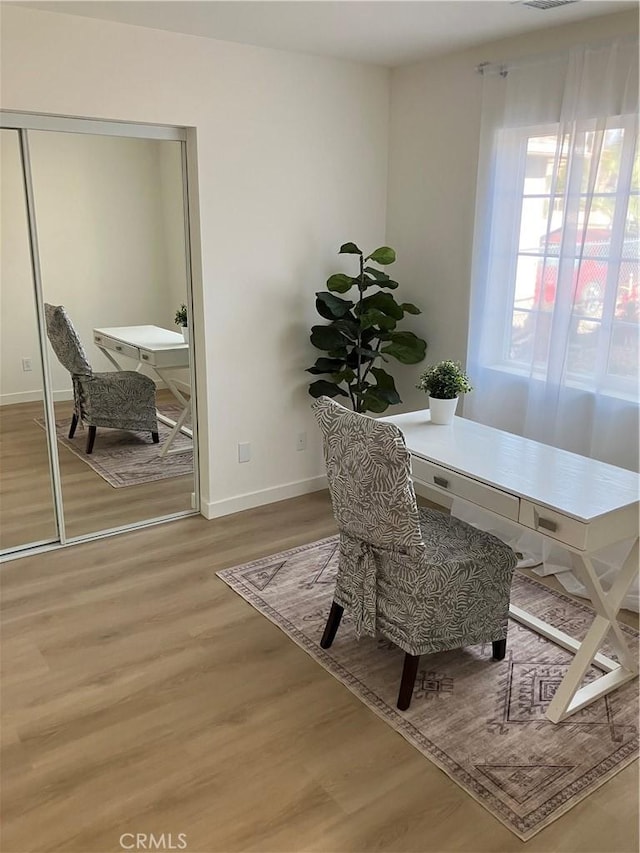 office area with baseboards and wood finished floors