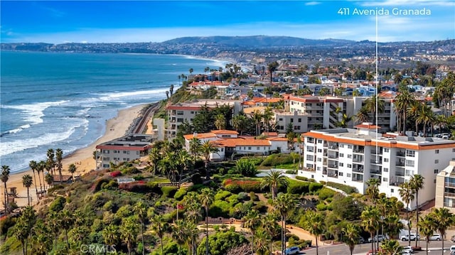 drone / aerial view with a view of the beach and a water and mountain view