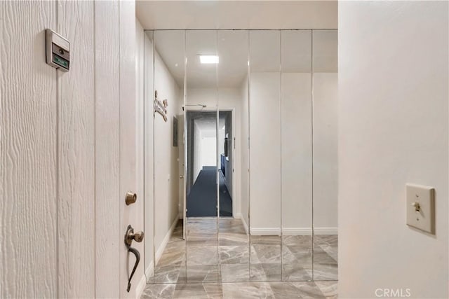 hallway with marble finish floor