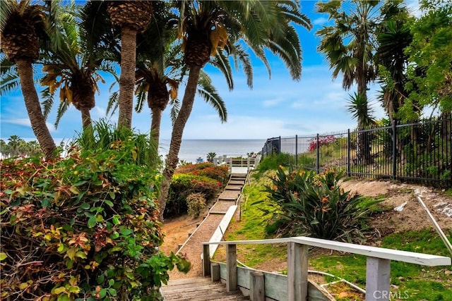 view of yard with a water view and fence