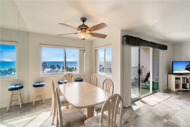 dining space featuring baseboards and ceiling fan