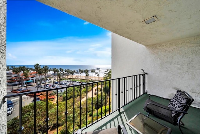 balcony featuring visible vents and a water view