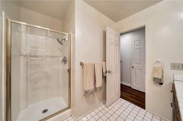 411 Avenida Granada Unit 2B, San Clemente, CA 92672 - full bathroom featuring a shower stall, baseboards, tile patterned flooring, and vanity