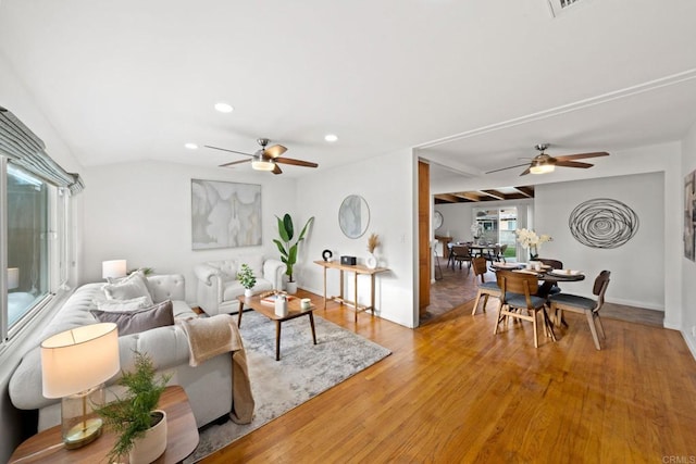 living room featuring light wood-style flooring, baseboards, a ceiling fan, and recessed lighting