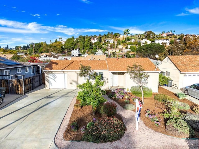 ranch-style home with a residential view, fence, and stucco siding