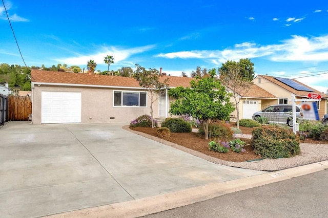 single story home with a garage, fence, concrete driveway, and stucco siding