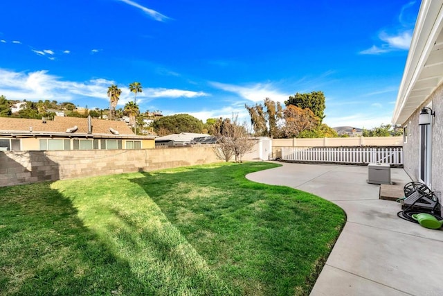 view of yard featuring a patio area and a fenced backyard