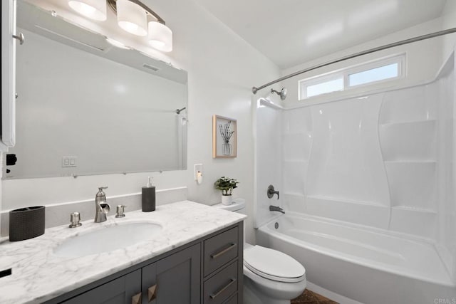 bathroom with visible vents, vanity, shower / tub combination, and toilet