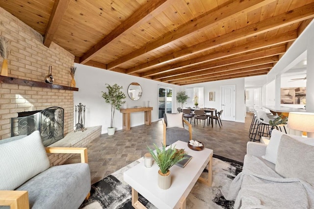 living room with stone finish floor, wood ceiling, a fireplace, and beam ceiling