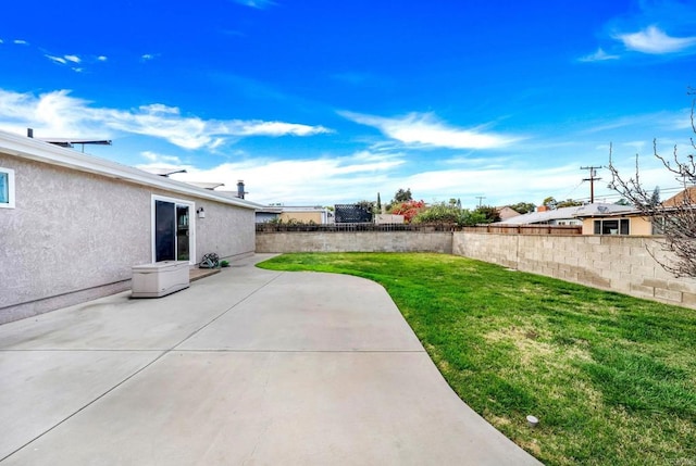 view of yard featuring fence and a patio