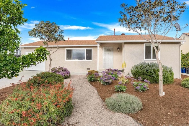 ranch-style home with an attached garage and stucco siding