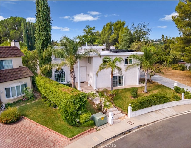 view of front of property featuring a front yard and stucco siding