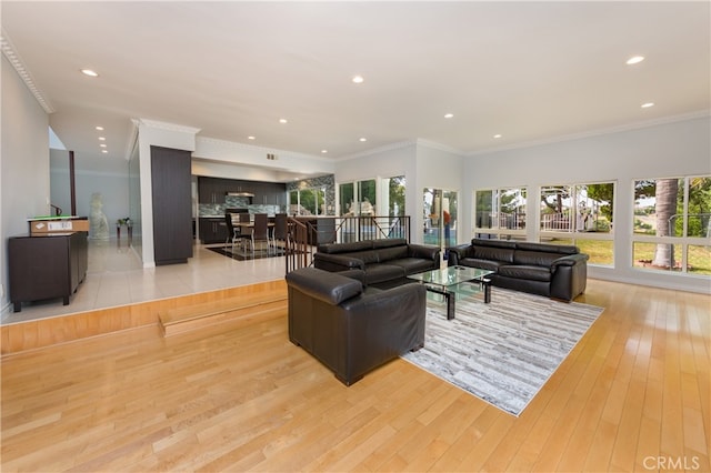 living area with recessed lighting, light wood-type flooring, and crown molding