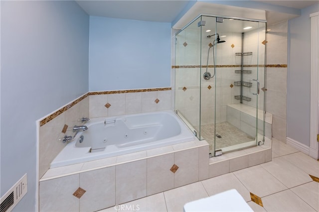 bathroom featuring a whirlpool tub, a stall shower, tile patterned flooring, and visible vents