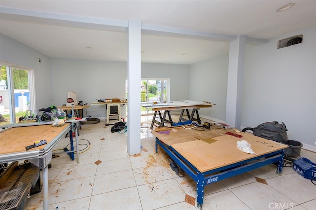 playroom with a healthy amount of sunlight, light tile patterned floors, and baseboards