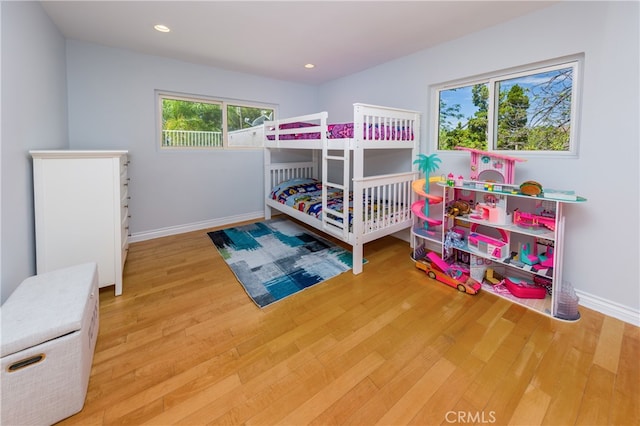 bedroom featuring recessed lighting, light wood-type flooring, and baseboards