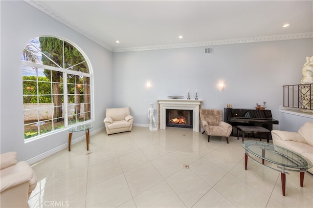 sitting room featuring light tile patterned floors, a lit fireplace, visible vents, and a wealth of natural light