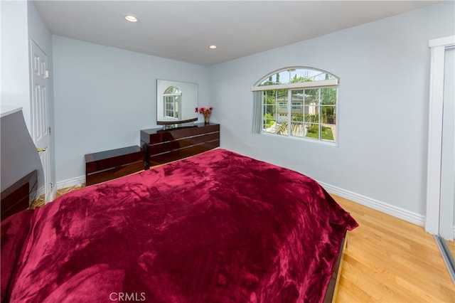 bedroom featuring recessed lighting, baseboards, and wood finished floors