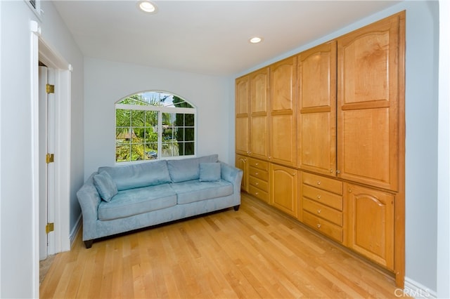 living area with light wood finished floors and recessed lighting