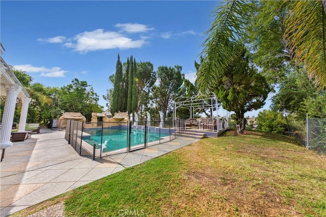 view of pool with a yard, a patio, a fenced backyard, and a fenced in pool