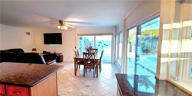 dining room featuring light tile patterned floors, baseboards, visible vents, and a ceiling fan