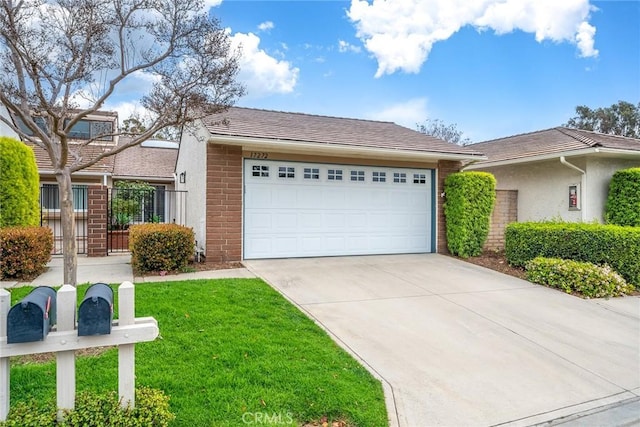 view of front facade with a garage, a front lawn, concrete driveway, and brick siding