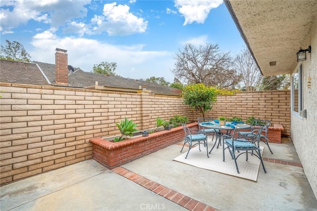 view of patio featuring outdoor dining area and a fenced backyard