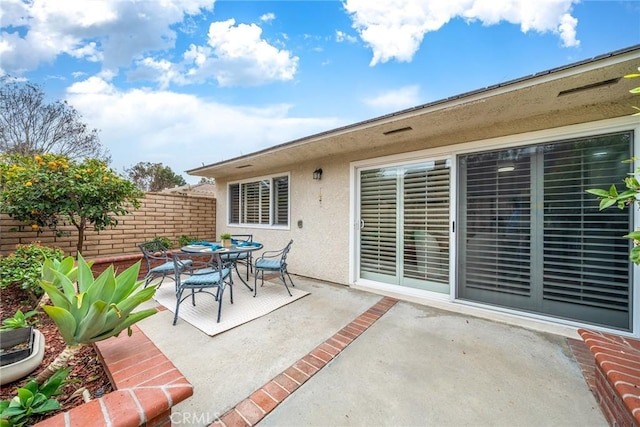 view of patio / terrace featuring outdoor dining area and fence