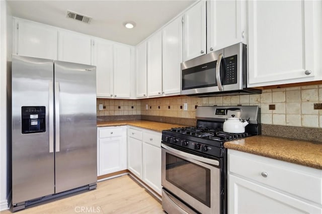 kitchen featuring appliances with stainless steel finishes and white cabinetry