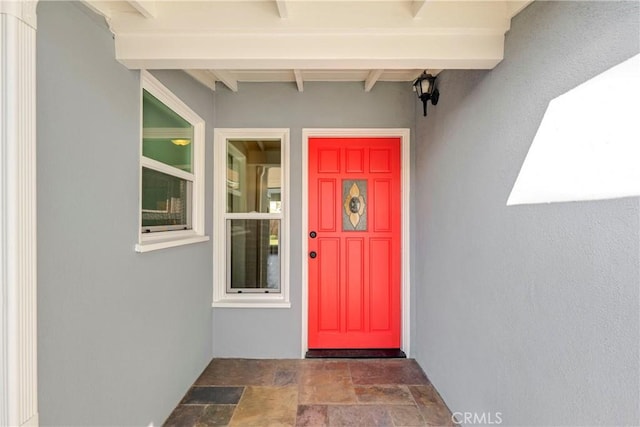 property entrance with stucco siding