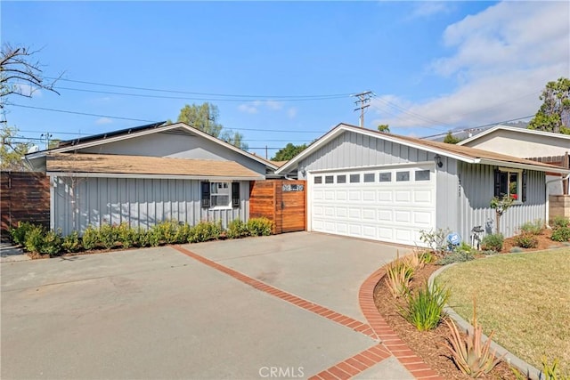 single story home with a garage and driveway