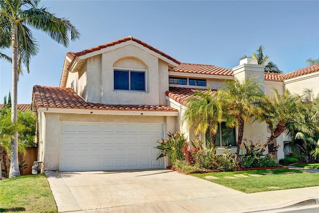 mediterranean / spanish home featuring driveway, an attached garage, a tile roof, and stucco siding