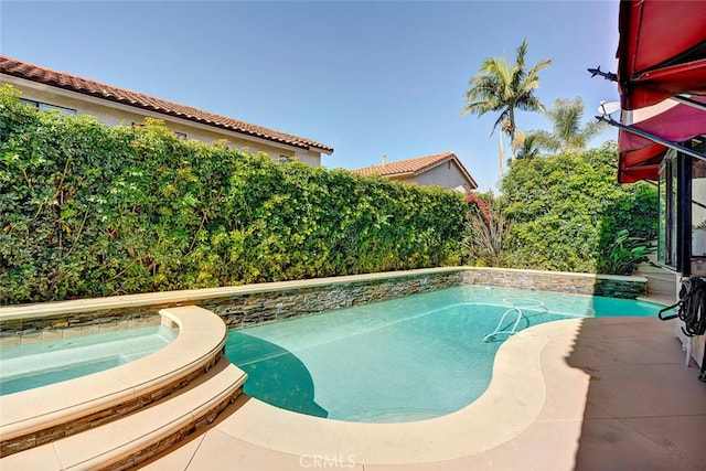 pool featuring a fenced backyard and an in ground hot tub