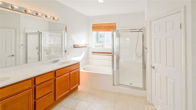 full bathroom featuring a sink, a bath, tile patterned floors, double vanity, and a stall shower