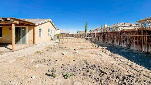 view of yard with a fenced backyard and central air condition unit