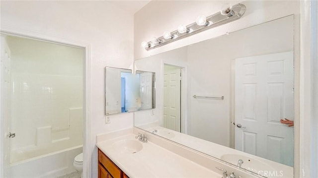 bathroom featuring toilet,  shower combination, and vanity