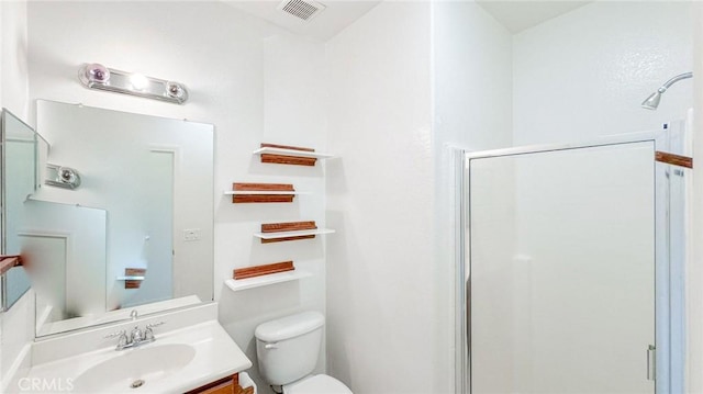 full bath with toilet, a stall shower, visible vents, and vanity